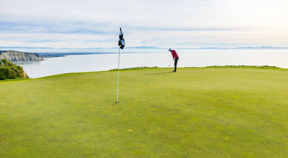 Teeing off at the Cape Kidnappers Golf Course, luxury New Zealand travel experiences