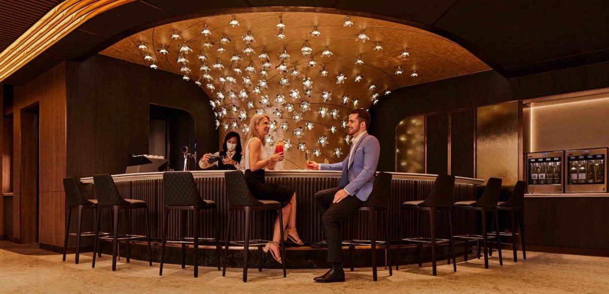 A man and woman sat at luxury bar