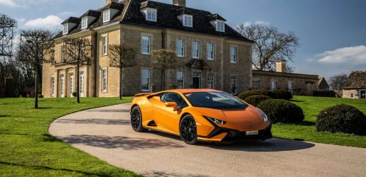 orange car in front of manor house
