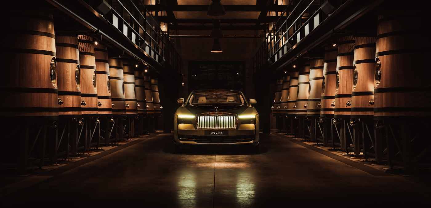a gold-hued Rolls-Royce Spectre in a cellar