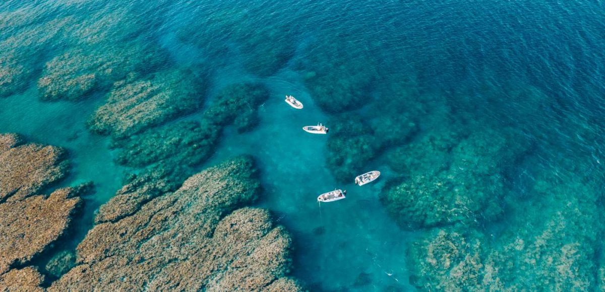boats floating over the reef